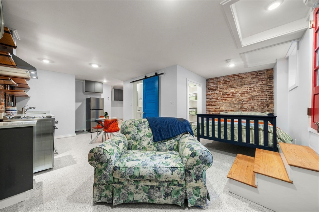 26 Unity Street, Unit 1 Boston, MA 02113 - Photo 15 of 27 a living room with furniture fireplace and a large window