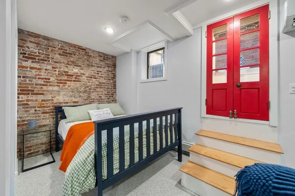 a bedroom with furniture and flat screen tv