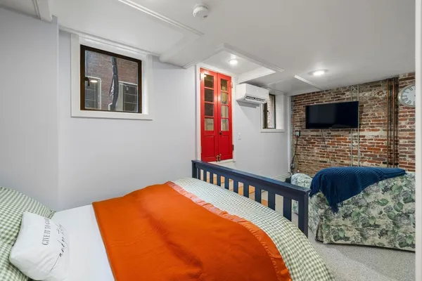 a bedroom with a bed and a chair