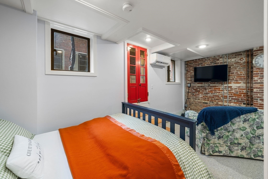 26 Unity Street, Unit 1 Boston, MA 02113 - Photo 18 of 27 a bedroom with furniture and flat screen tv