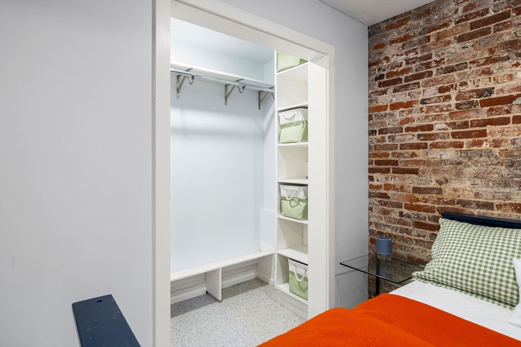 26 Unity Street, Unit 1 Boston, MA 02113 - Photo 19 of 27 a bedroom with a bed and a chair