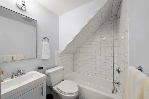 a bathroom with a toilet and a bathtub