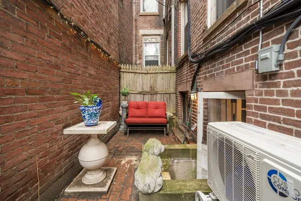a view of patio with a table and chairs