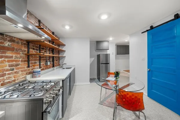 a view of kitchen with furniture and refrigerator