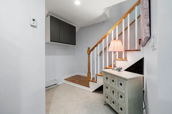 a view of an entryway with wooden floor