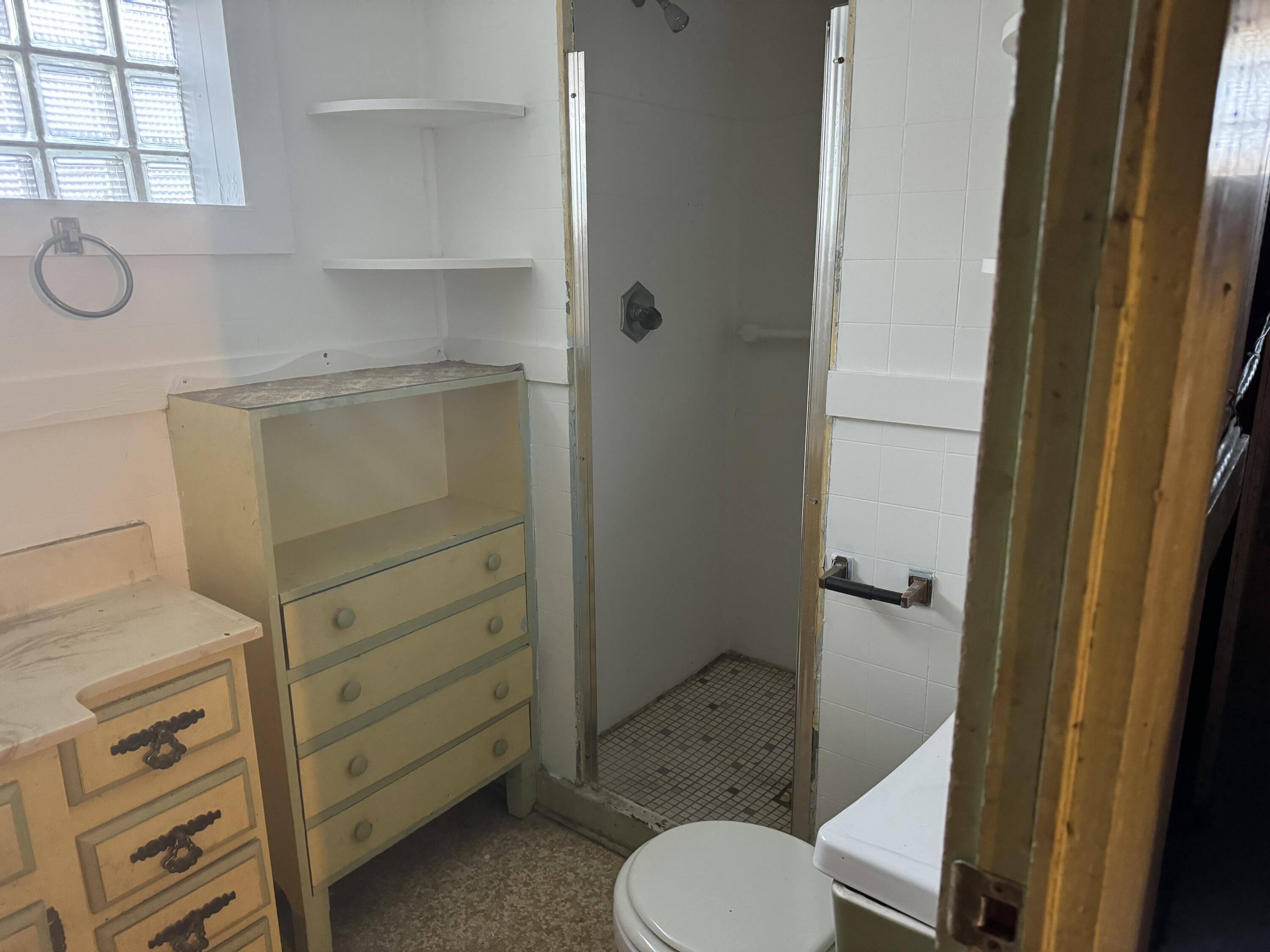 217 West Ripley Street Michigan City, IN 46360 - Photo 18 of 28 a bathroom with a sink toilet and window