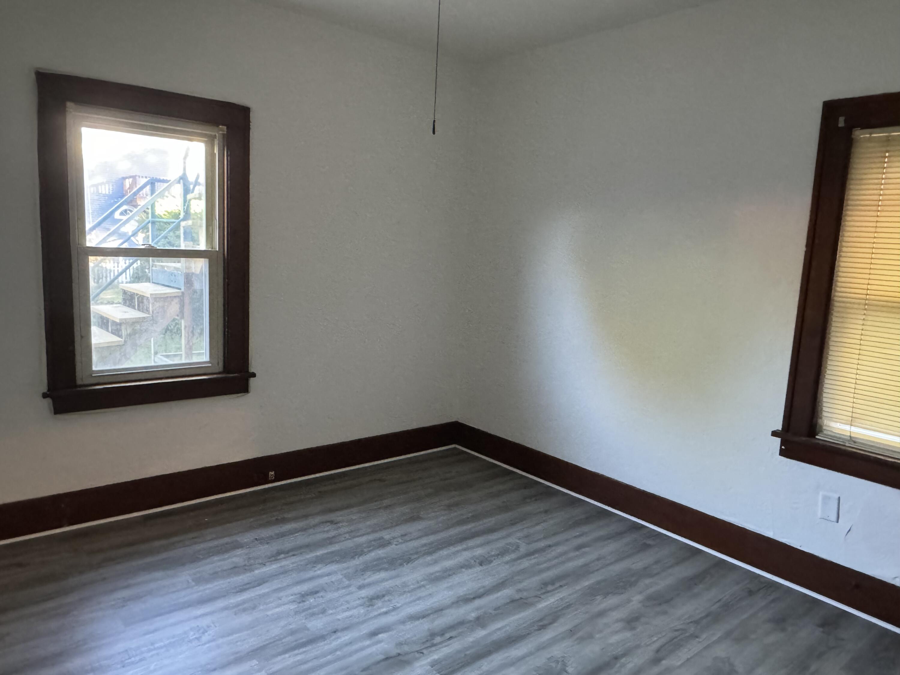 217 West Ripley Street Michigan City, IN 46360 - Photo 10 of 28 a view of a room with wooden floor and a window