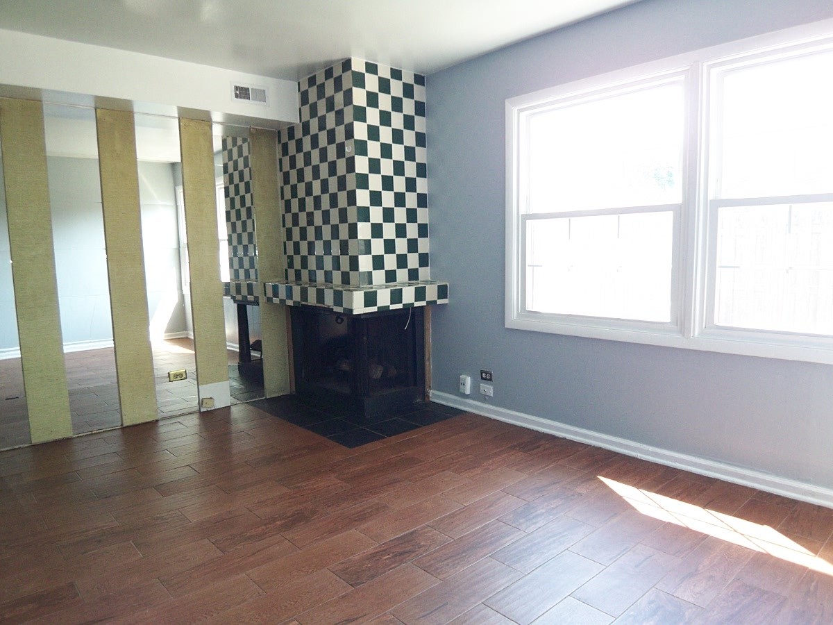 1925 Georgetown Lane Hoffman Estates, IL 60169 - Photo 15 of 29 an empty room with wooden floor and windows