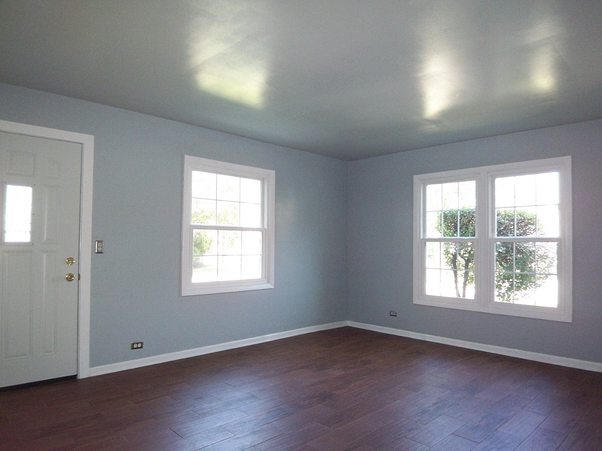 1925 Georgetown Lane Hoffman Estates, IL 60169 - Photo 2 of 29 an empty room with wooden floor and windows