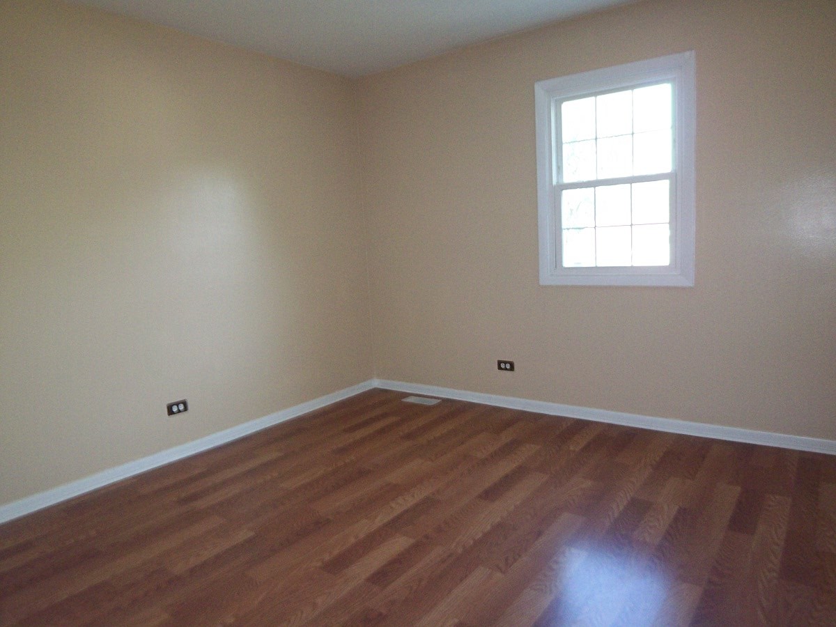 1925 Georgetown Lane Hoffman Estates, IL 60169 - Photo 25 of 29 an empty room with wooden floor and windows