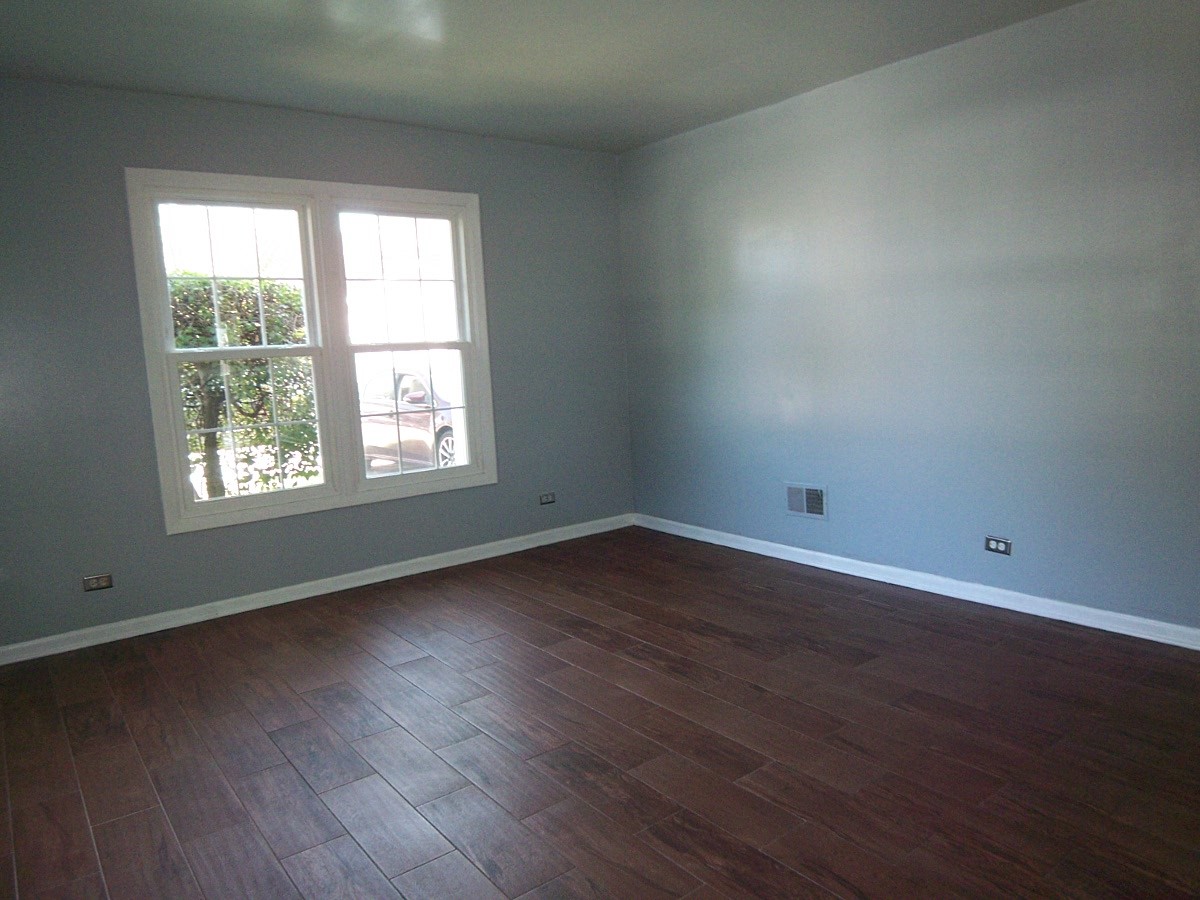 1925 Georgetown Lane Hoffman Estates, IL 60169 - Photo 3 of 29 an empty room with wooden floor and windows
