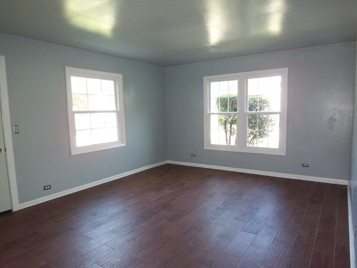 1925 Georgetown Lane Hoffman Estates, IL 60169 - Photo 5 of 29 an empty room with wooden floor and windows