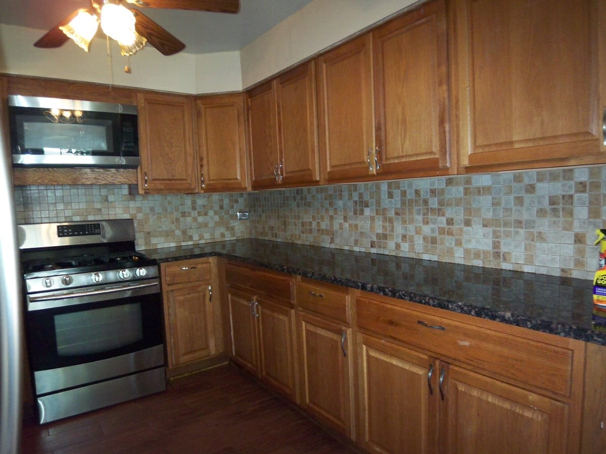 1925 Georgetown Lane Hoffman Estates, IL 60169 - Photo 6 of 29 a kitchen with granite countertop wood cabinets and stainless steel appliances