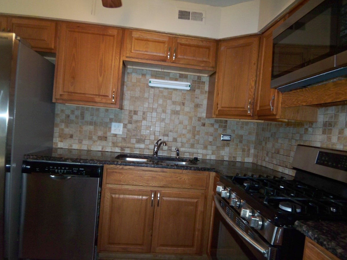 1925 Georgetown Lane Hoffman Estates, IL 60169 - Photo 8 of 29 a kitchen with granite countertop a sink stove and cabinets