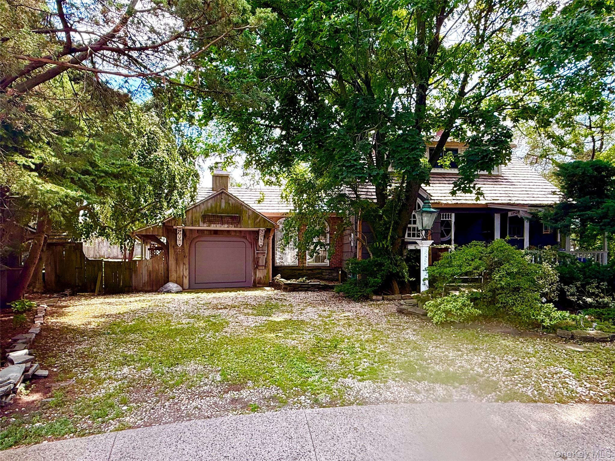 335 Arthur Street Freeport, NY 11520 - Photo 1 of 17 a front view of a house with a garden and tree