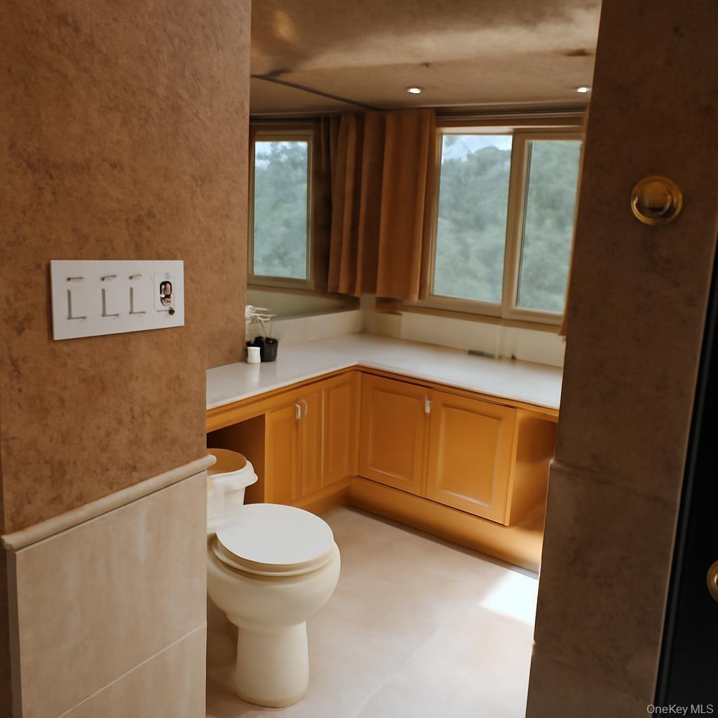 335 Arthur Street Freeport, NY 11520 - Photo 17 of 17 a bathroom with a sink a toilet and a mirror