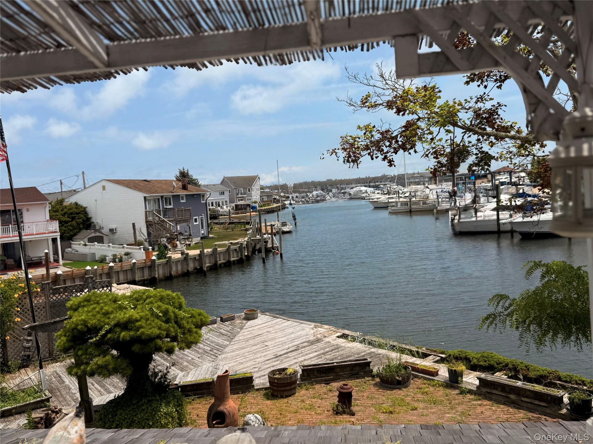 335 Arthur Street Freeport, NY 11520 - Photo 3 of 17 a view of a lake with boats and palm trees