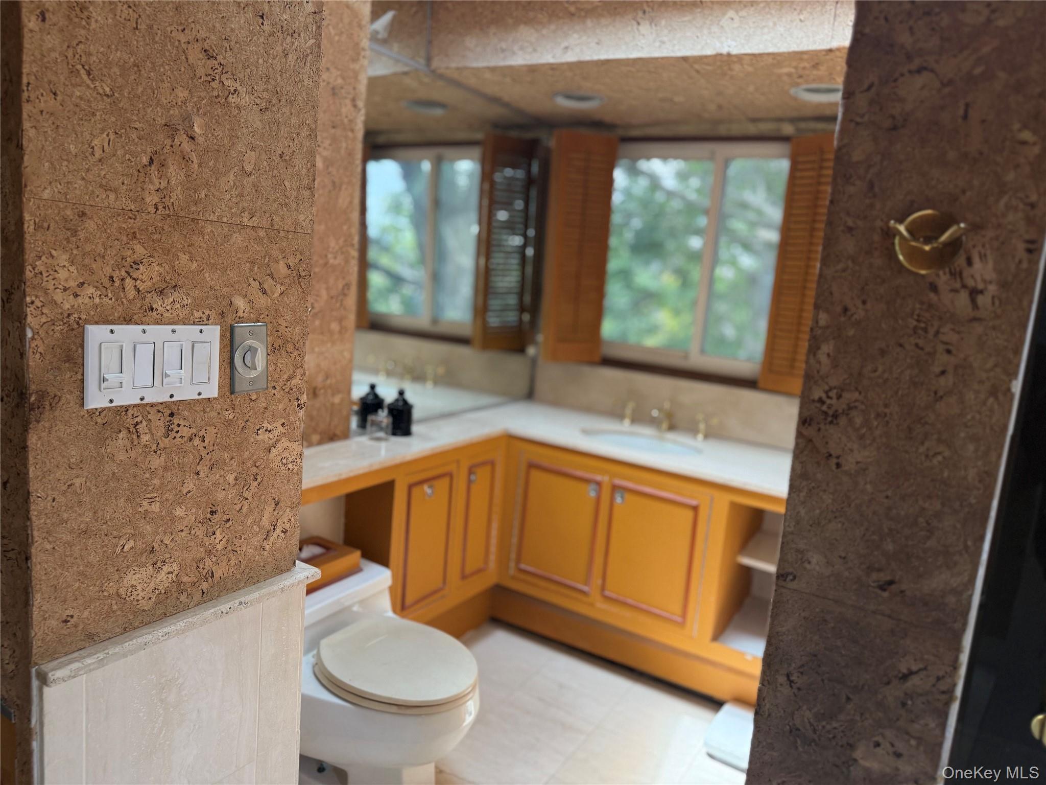 335 Arthur Street Freeport, NY 11520 - Photo 8 of 17 a bathroom with a granite countertop toilet sink and mirror
