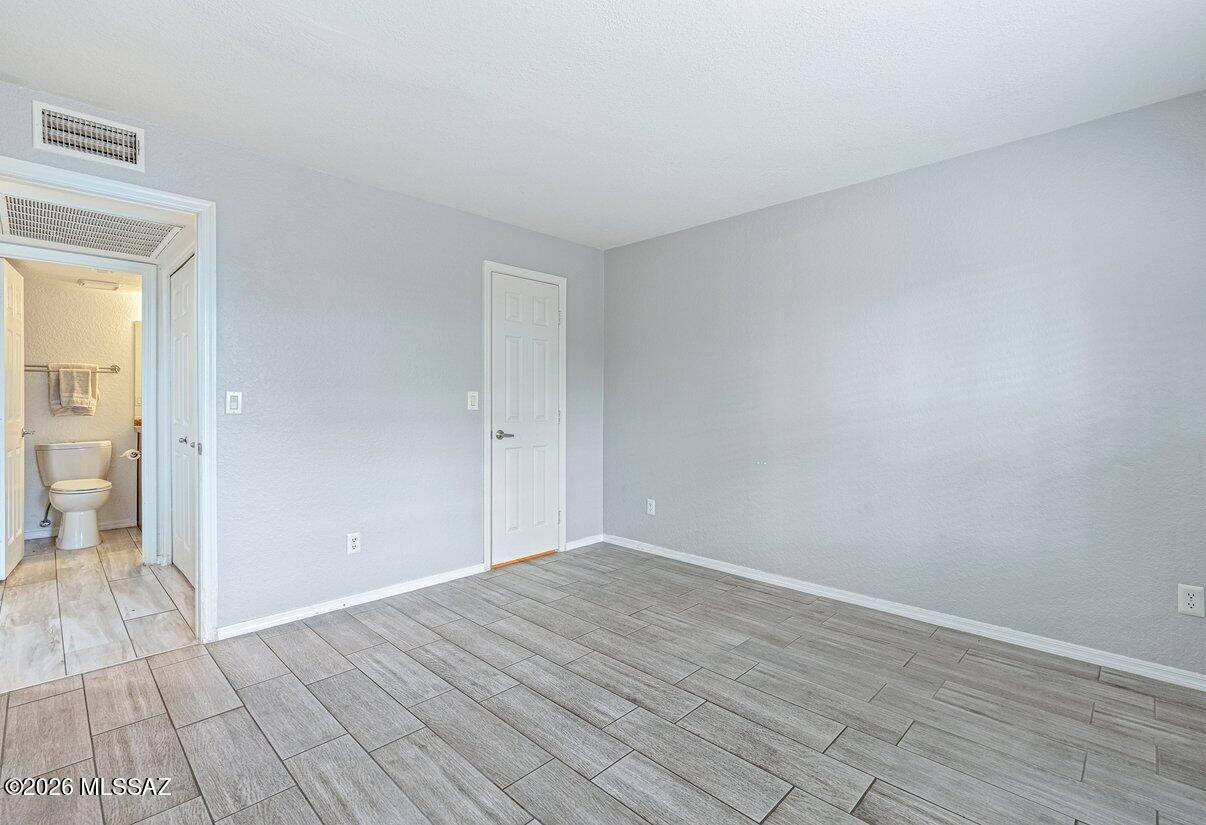 5800 North Kolb Road, Unit 1104 Tucson, AZ 85750 - Photo 15 of 29 Bedroom two looking towards bathroom number two and the walk-in closet.