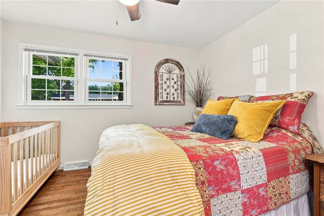 204 Sylvia Road Easley, SC 29642 - Photo 21 of 36 Well-lit sleeping quarters with natural wood flooring and a refreshing ceiling fan.