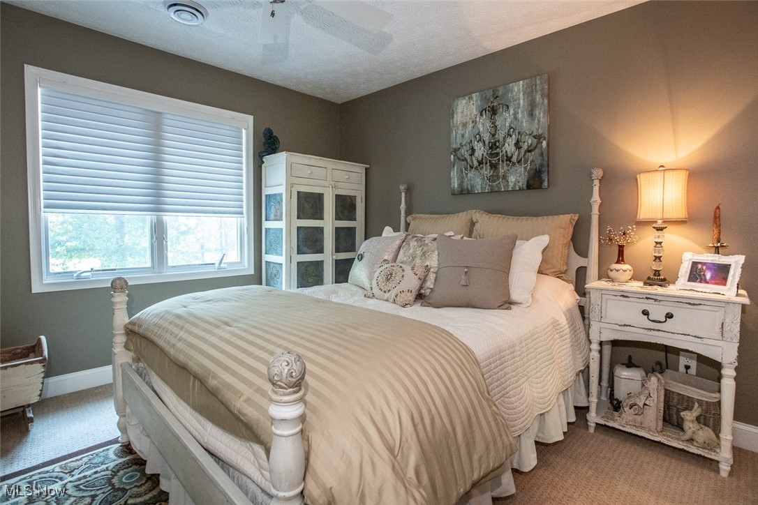 632 Rundle Street Lagrange, OH 44050 - Photo 27 of 30 Bedroom with ceiling fan, a textured ceiling, and carpet floors