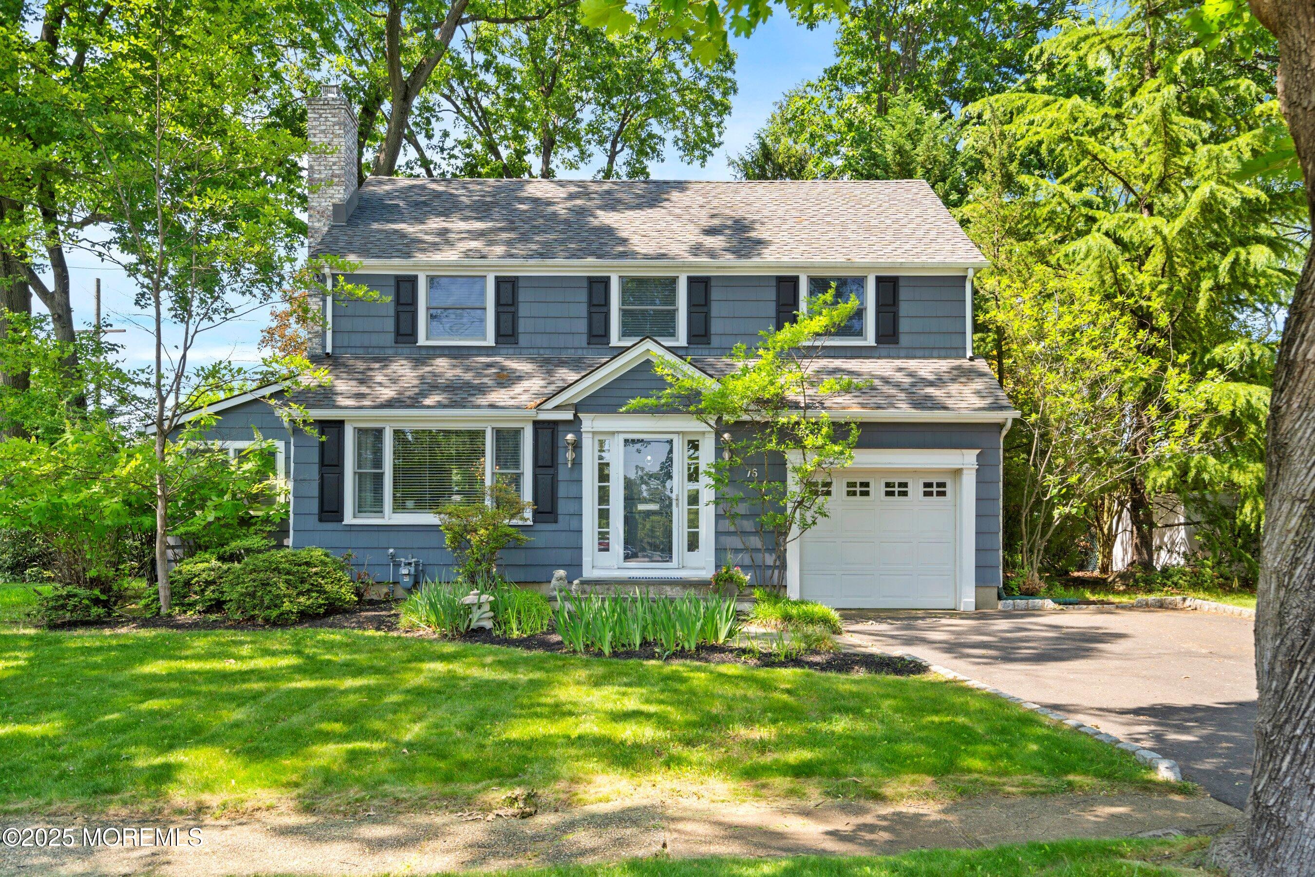 a front view of a house with a garden and plants