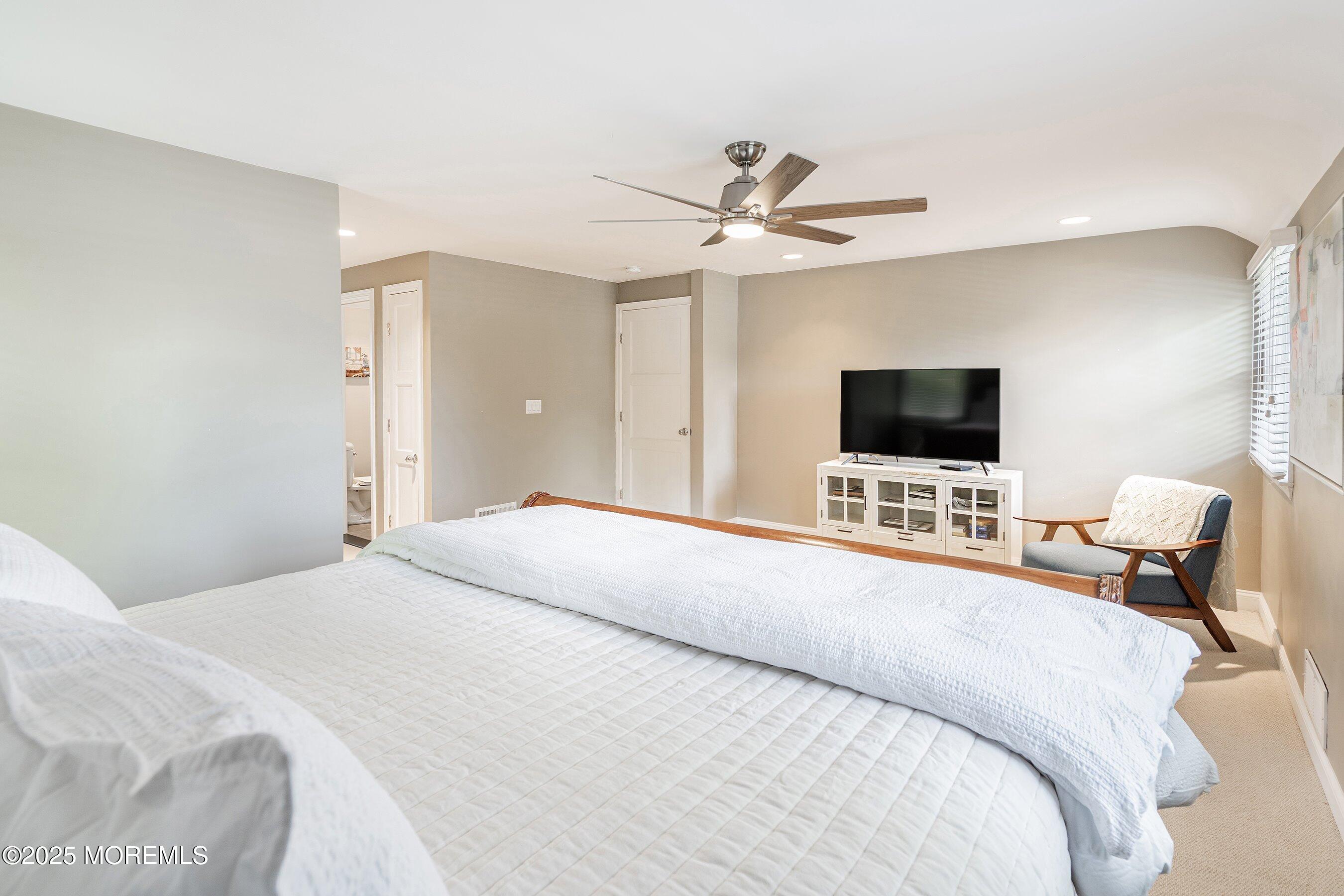 76 Ridge Road Fair Haven, NJ 07704 - Photo 14 of 22 a bedroom with a bed and a flat screen tv