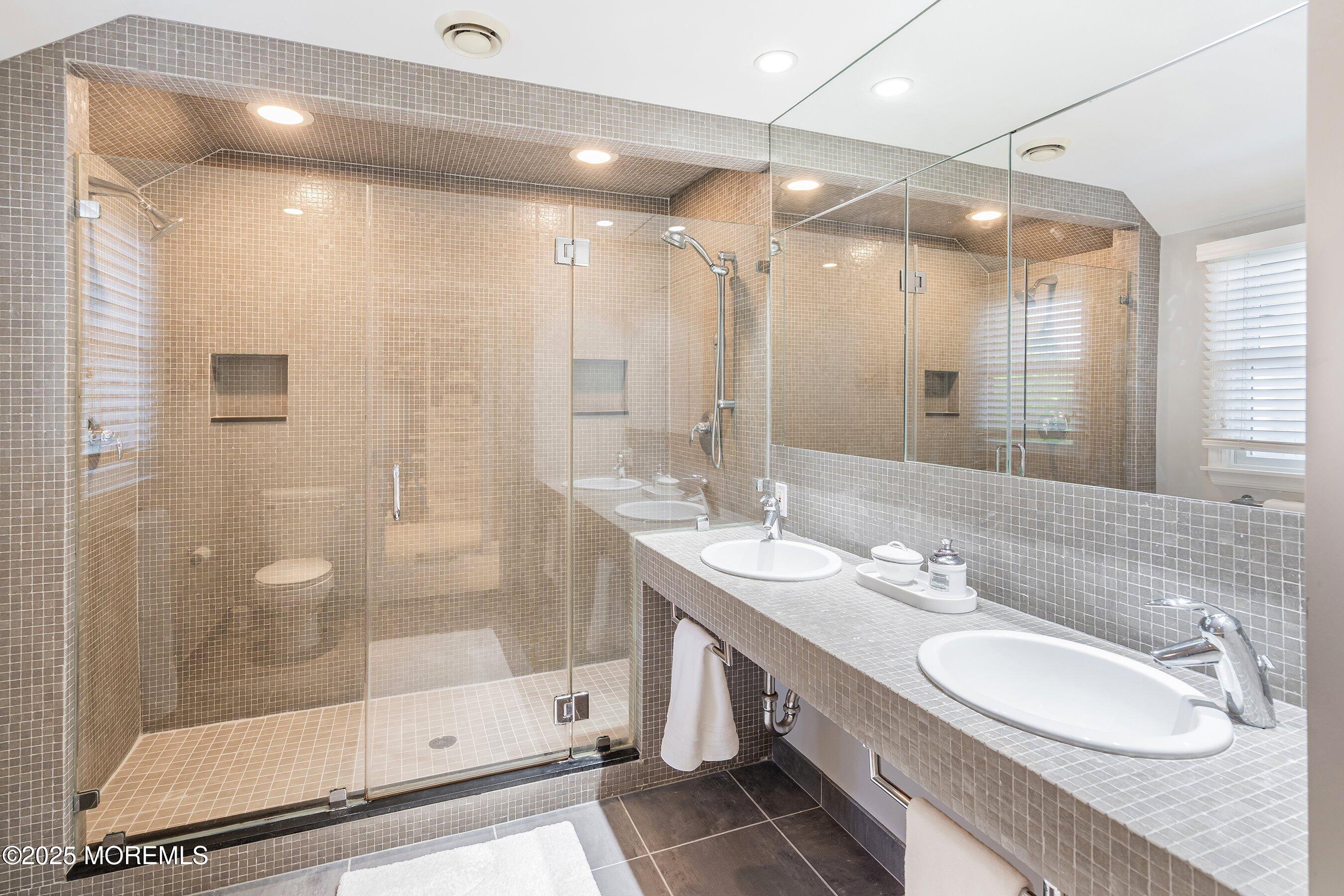 76 Ridge Road Fair Haven, NJ 07704 - Photo 15 of 22 a bathroom with a double vanity sink mirror and shower