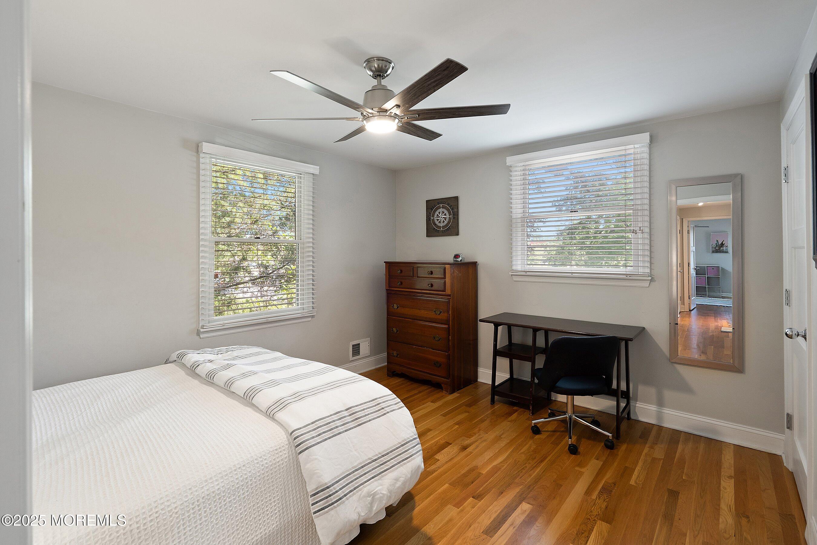 76 Ridge Road Fair Haven, NJ 07704 - Photo 18 of 22 a bedroom with a bed a desk and chair with a window