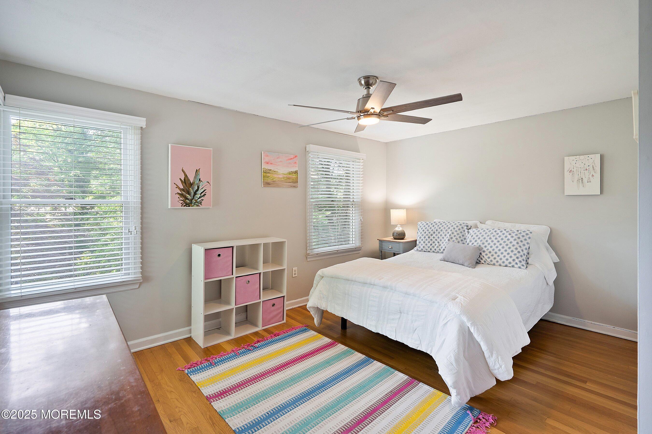 76 Ridge Road Fair Haven, NJ 07704 - Photo 19 of 22 a bedroom with a bed and a chandelier