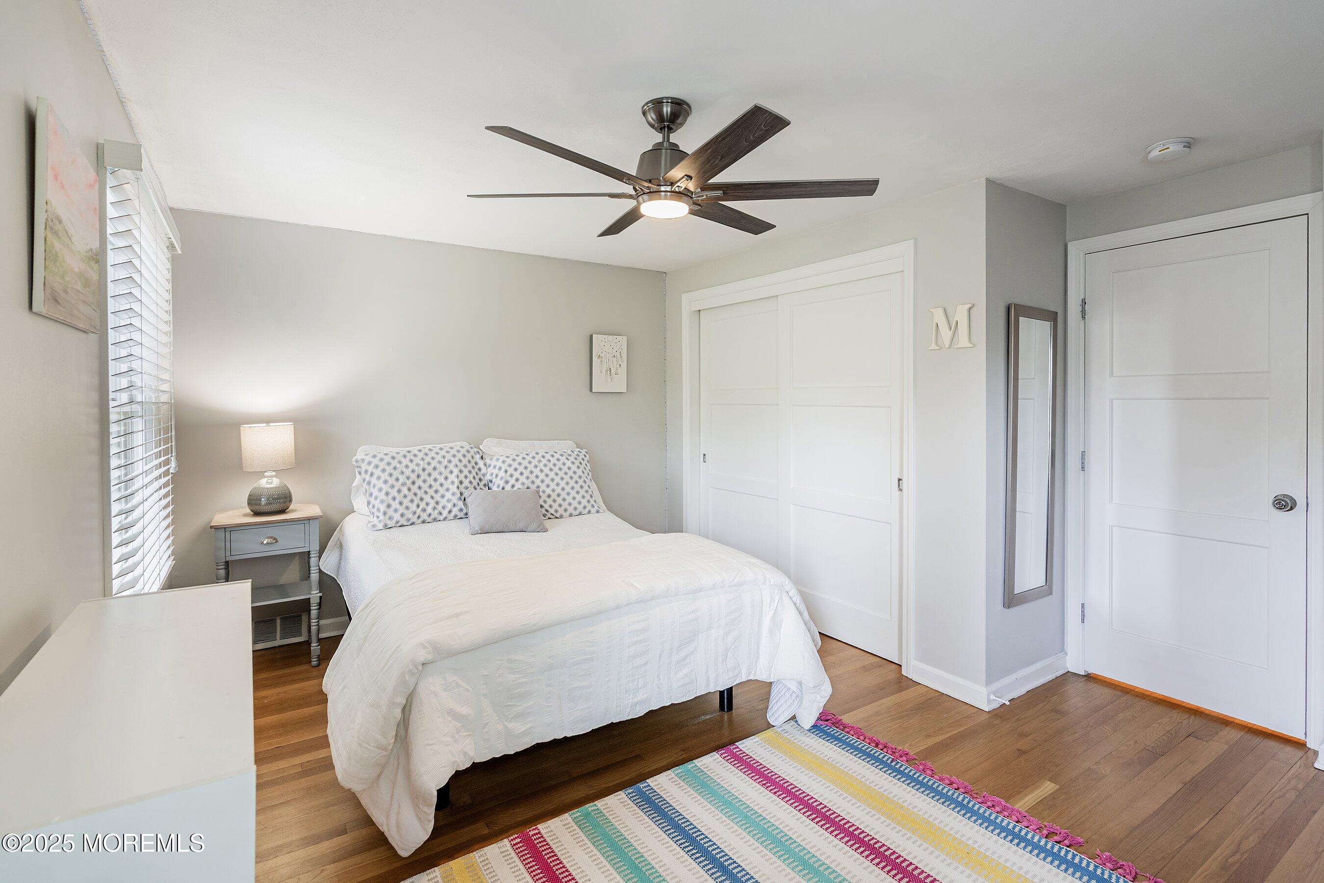 76 Ridge Road Fair Haven, NJ 07704 - Photo 20 of 22 a bedroom with a bed and a chandelier