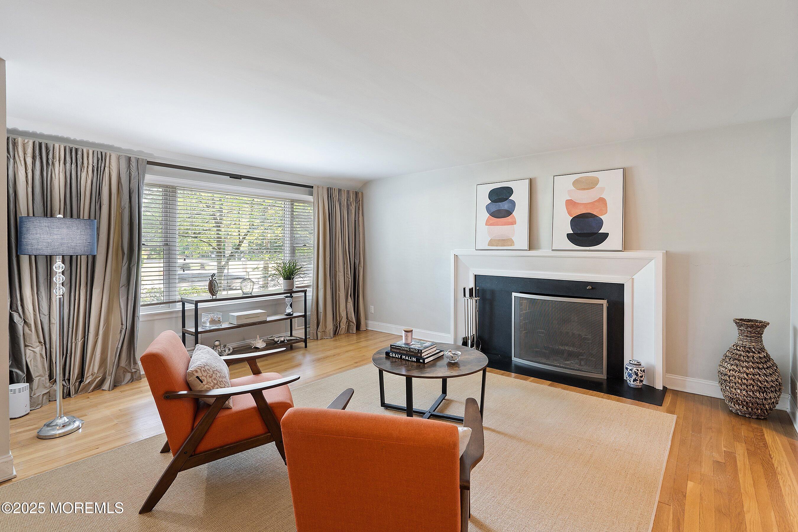 76 Ridge Road Fair Haven, NJ 07704 - Photo 3 of 22 a living room with furniture a fireplace and a flat screen tv