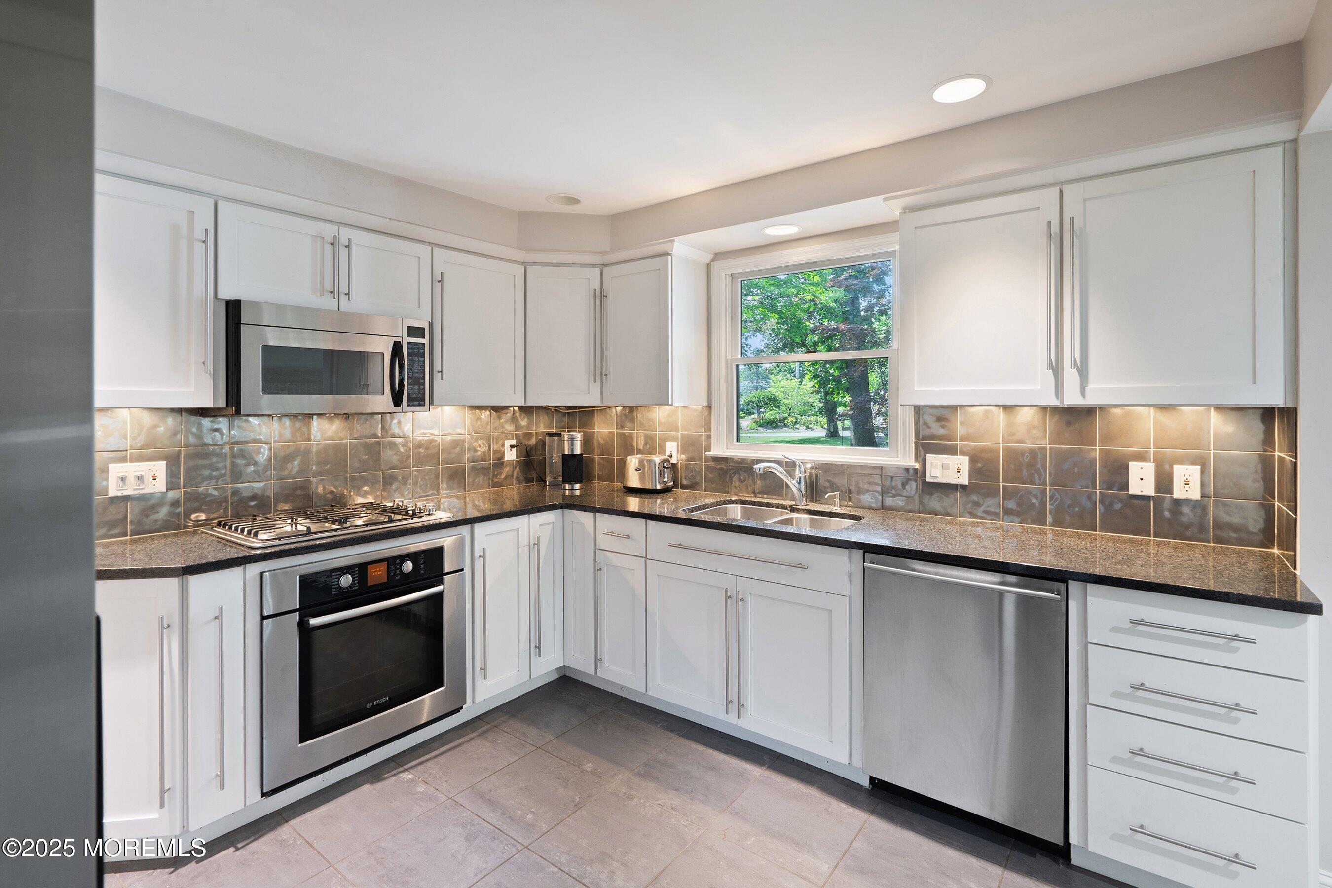 76 Ridge Road Fair Haven, NJ 07704 - Photo 8 of 22 a kitchen with granite countertop white cabinets and window