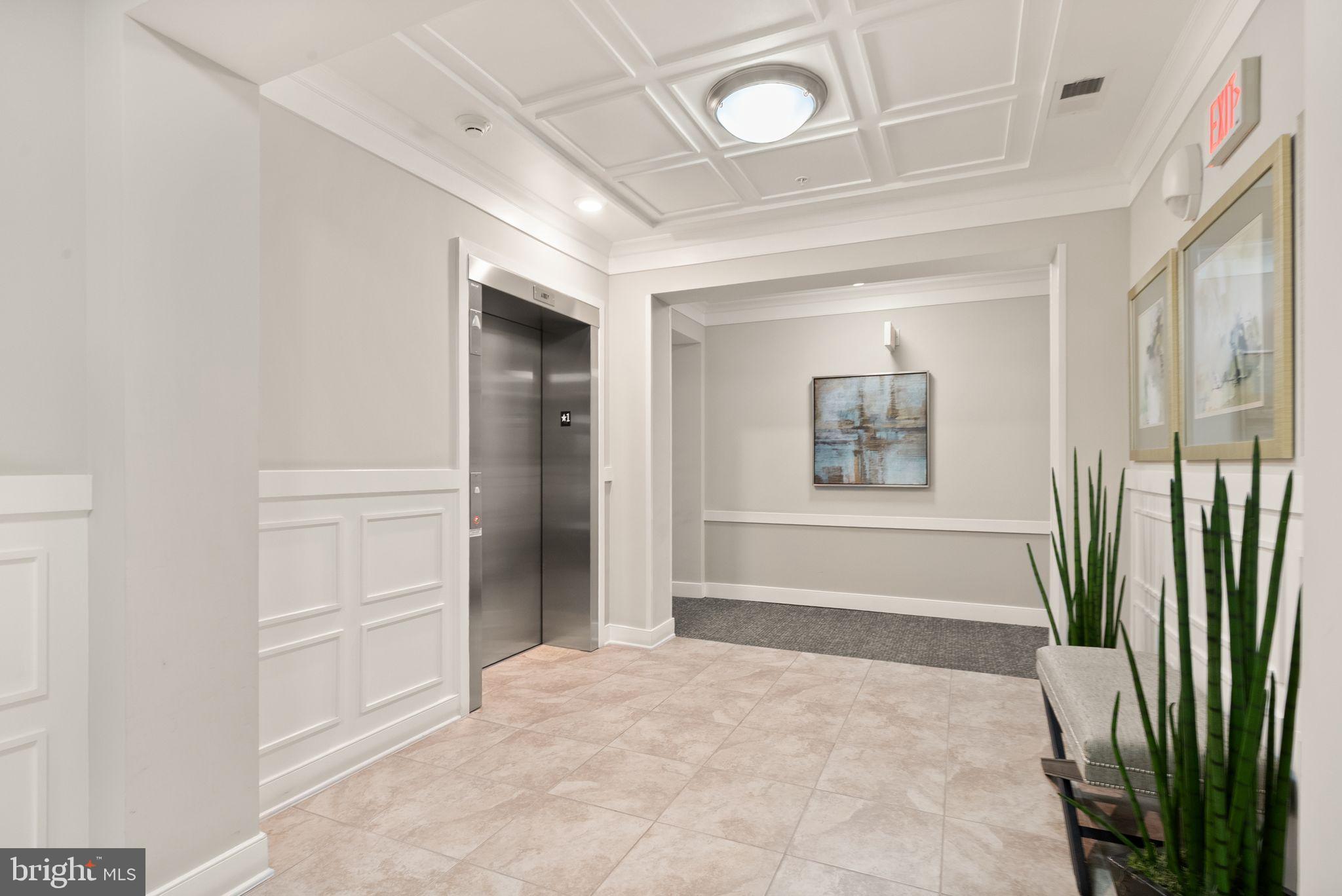 20610 Hope Spring Terrace, Unit 104 Ashburn, VA 20147 - Photo 2 of 38 Elegant lobby with modern accents.
