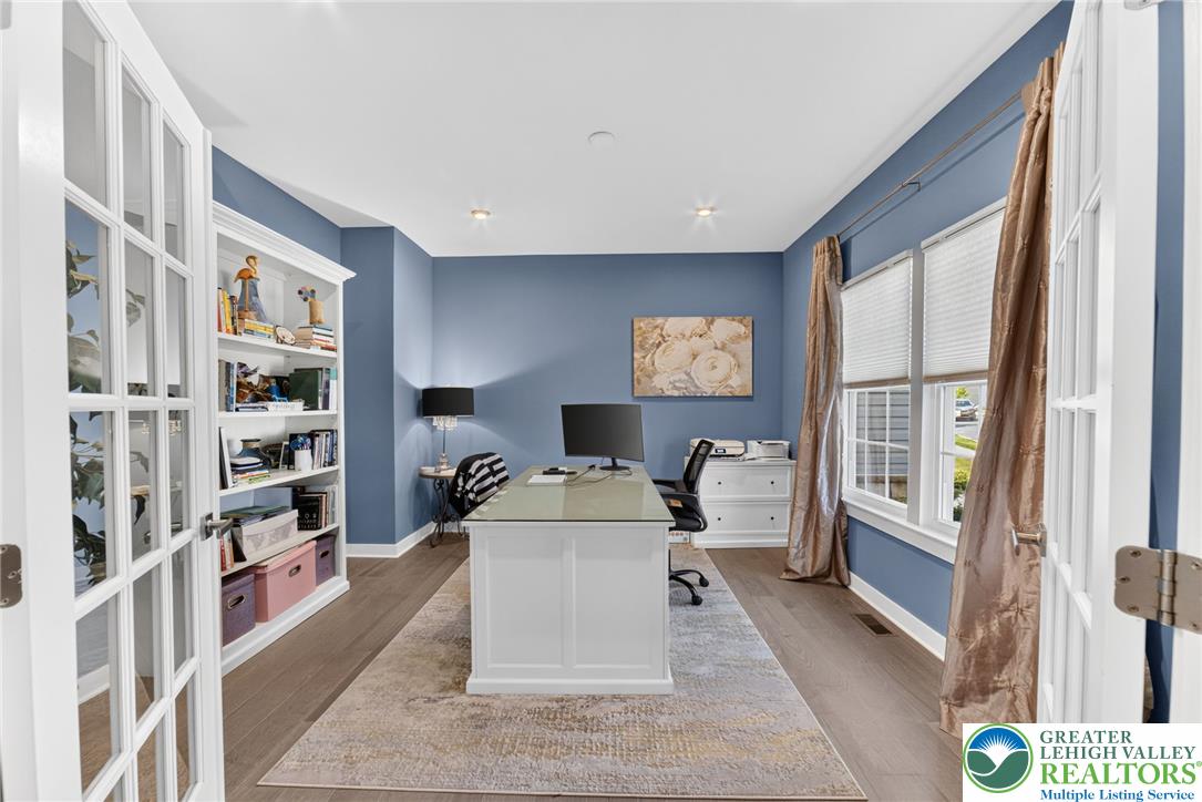 3952 Orth Street Bethlehem, PA 18020 - Photo 10 of 60 French doors lead into this well-lit home office, complete with ample shelving and sleek hardwood floors.