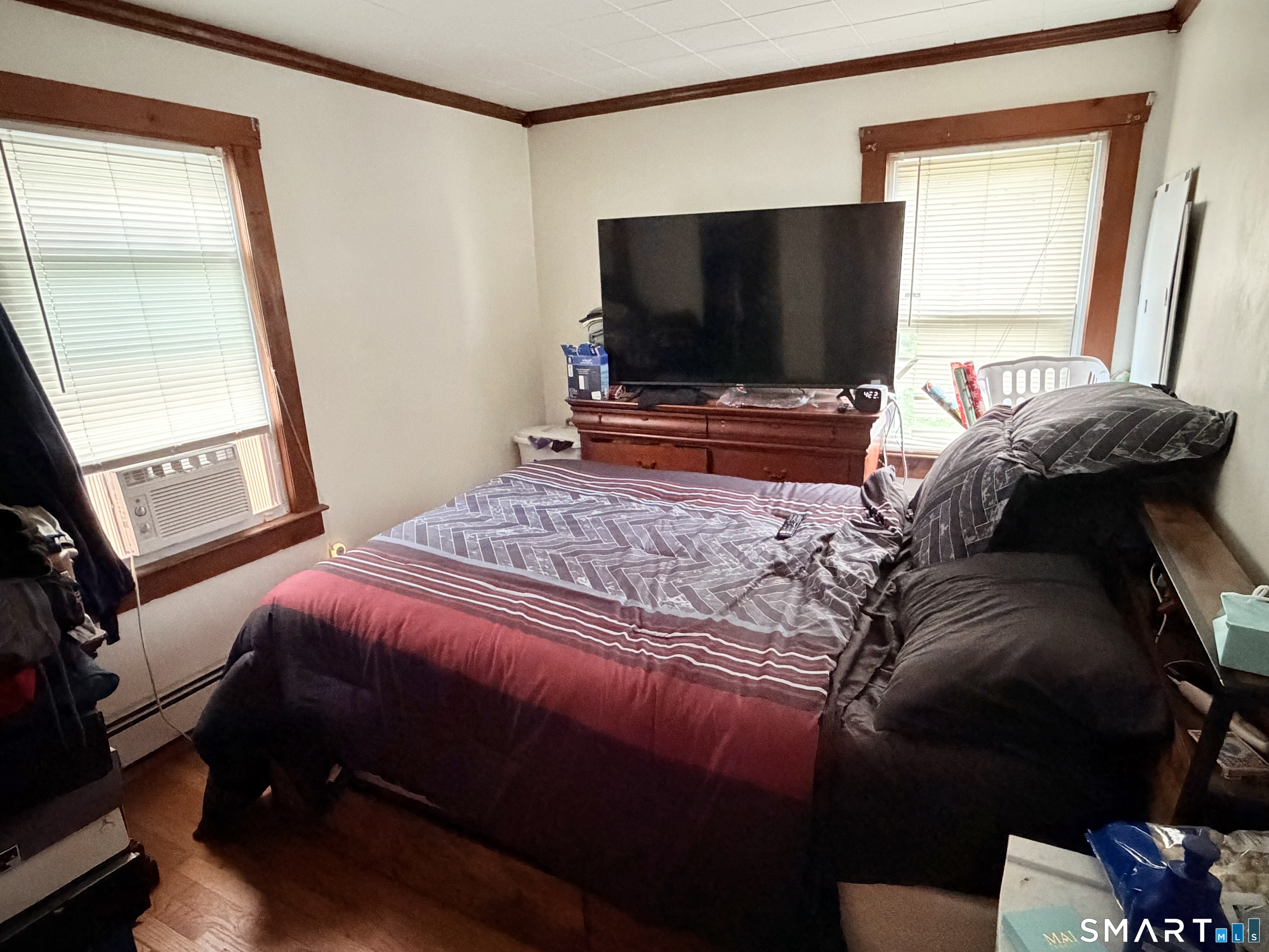 67 Pine Street Meriden, CT 06451 - Photo 19 of 34 a bedroom with a bed and a flat screen tv