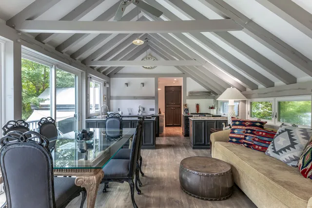 a dining room with furniture water view and a kitchen view