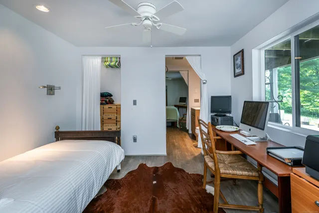 a bedroom with a bed and a desk