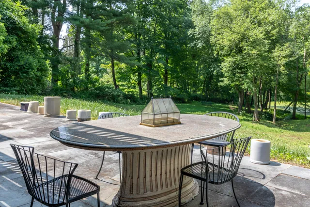 a view of backyard with swimming pool and green space