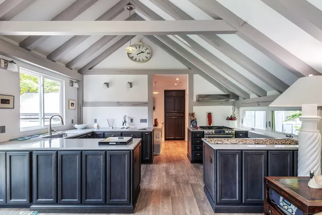 a kitchen with stainless steel appliances granite countertop a stove a sink and a refrigerator