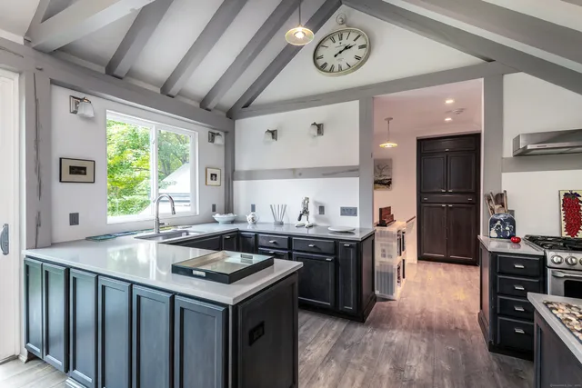 a kitchen with a stove a sink and a refrigerator