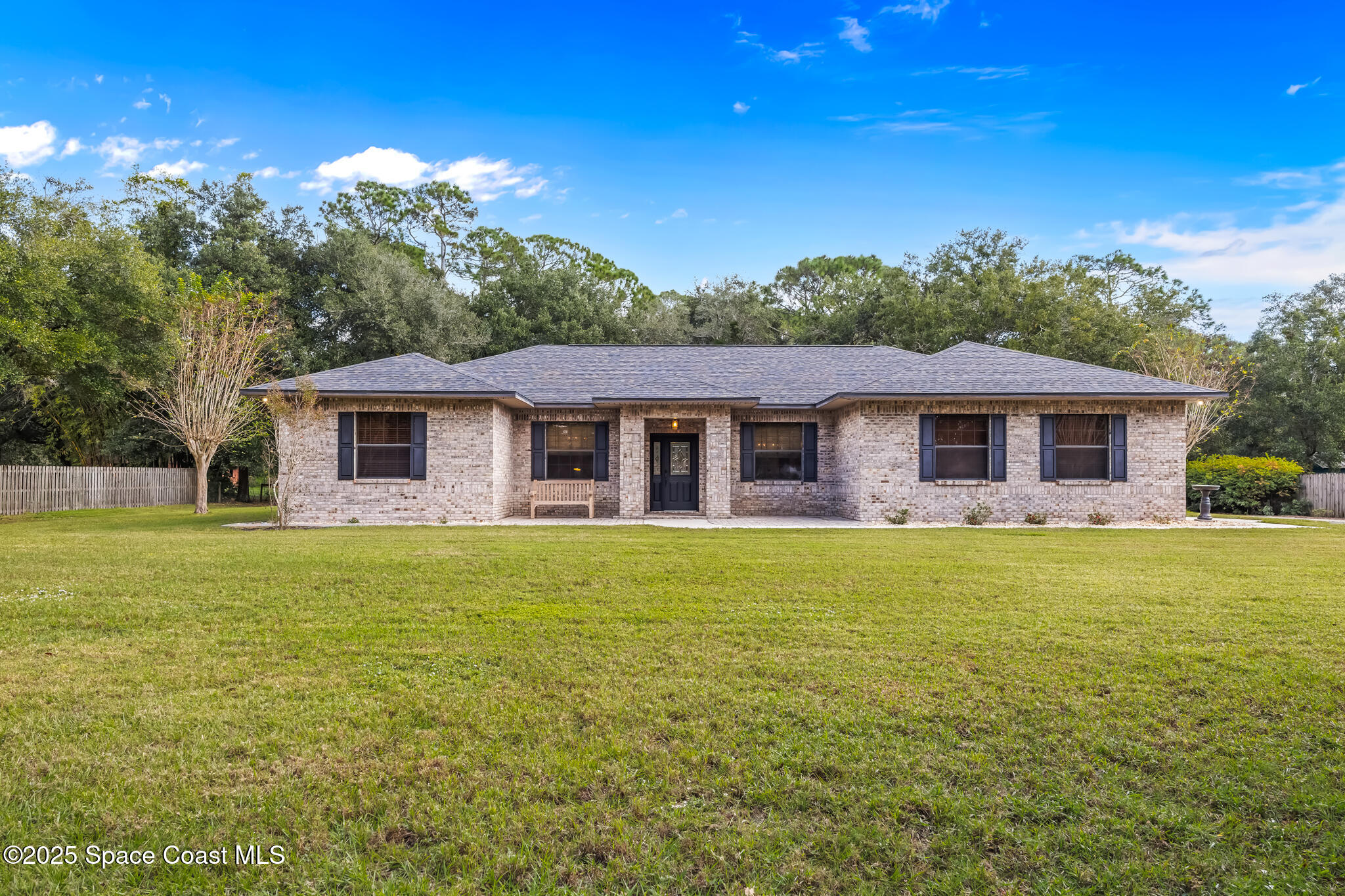 5495 Pine Street Cocoa, FL 32927 - Photo 1 of 45 a front view of a house with a garden