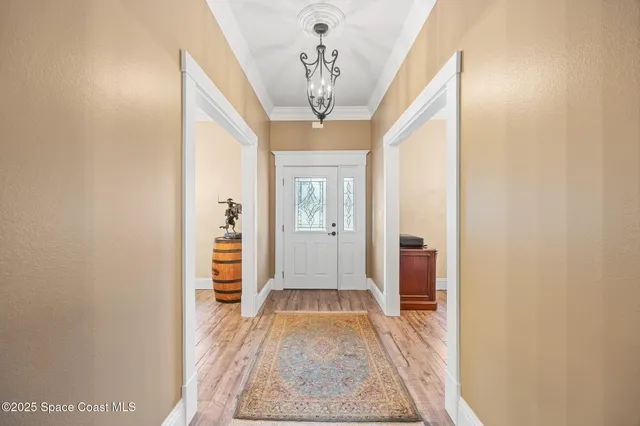 a view of a hallway view with wooden floor and staircase