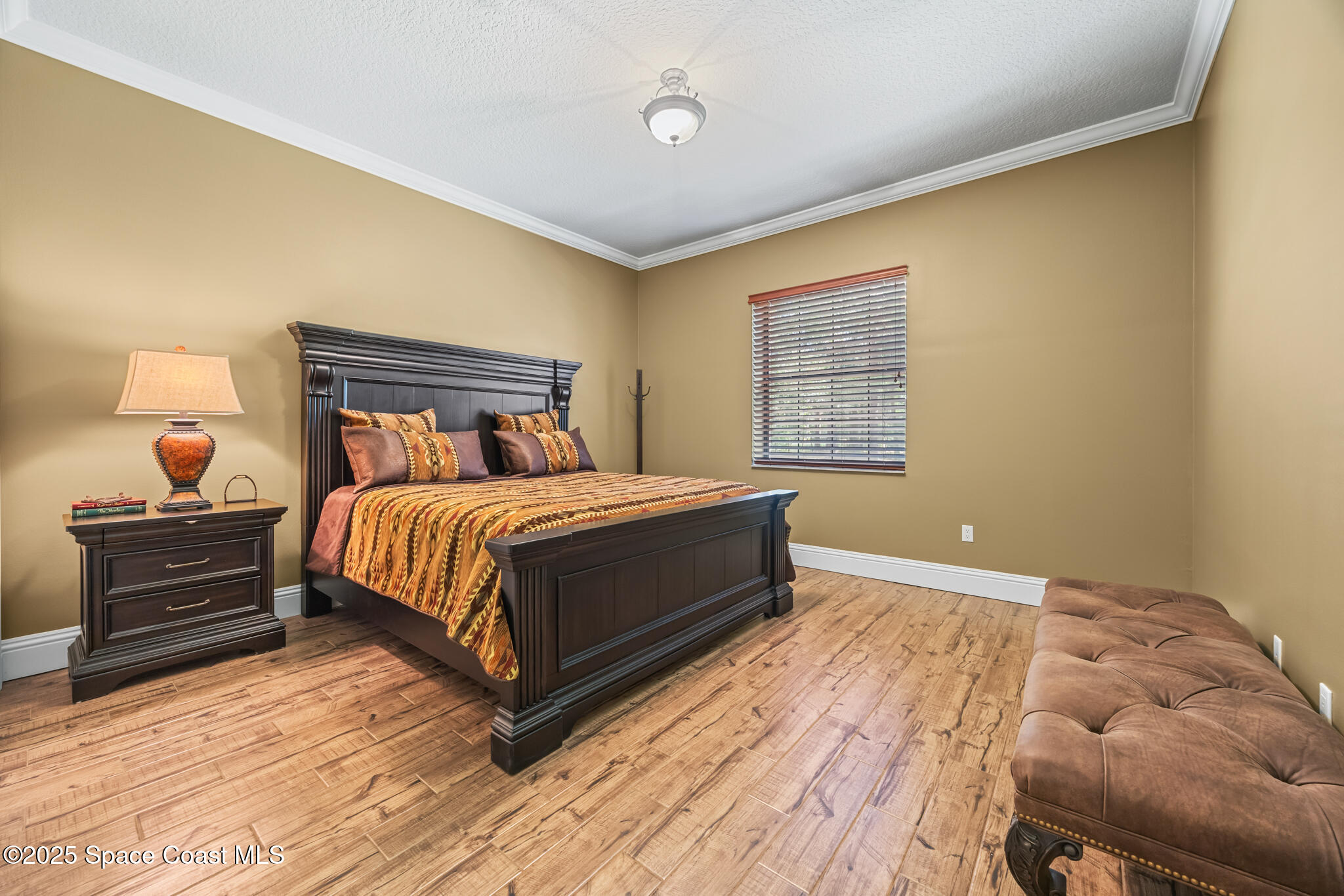 5495 Pine Street Cocoa, FL 32927 - Photo 12 of 45 a bedroom with a bed and wooden floor