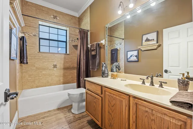 a bathroom with a double vanity sink toilet mirror and shower
