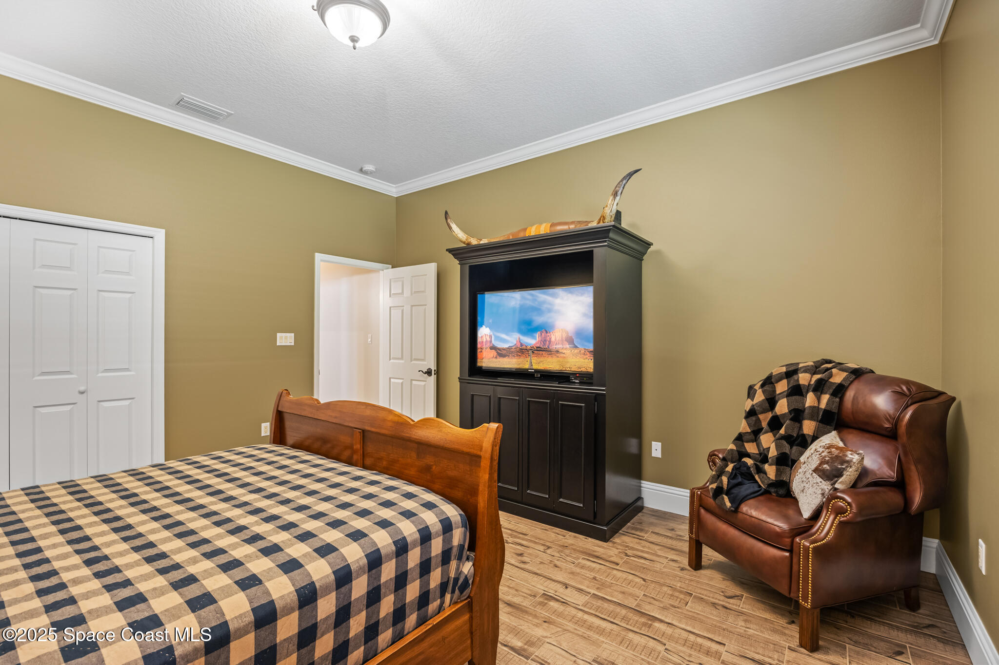 5495 Pine Street Cocoa, FL 32927 - Photo 16 of 45 a bedroom with a bed and chair