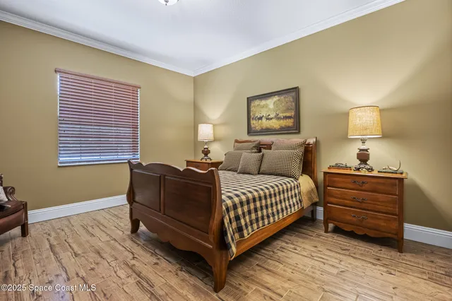a living room with a bed and a lamp on table