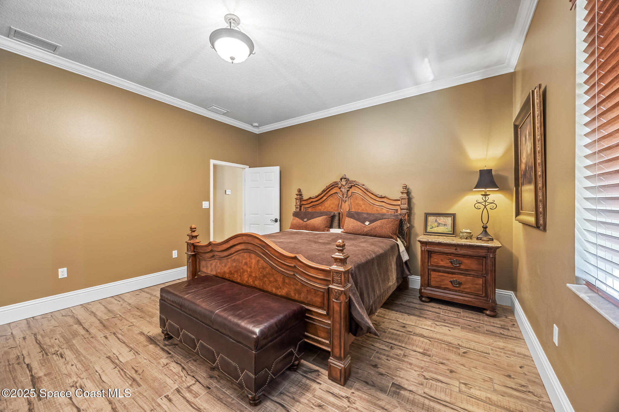 5495 Pine Street Cocoa, FL 32927 - Photo 18 of 45 a bedroom with a bed and wooden floor