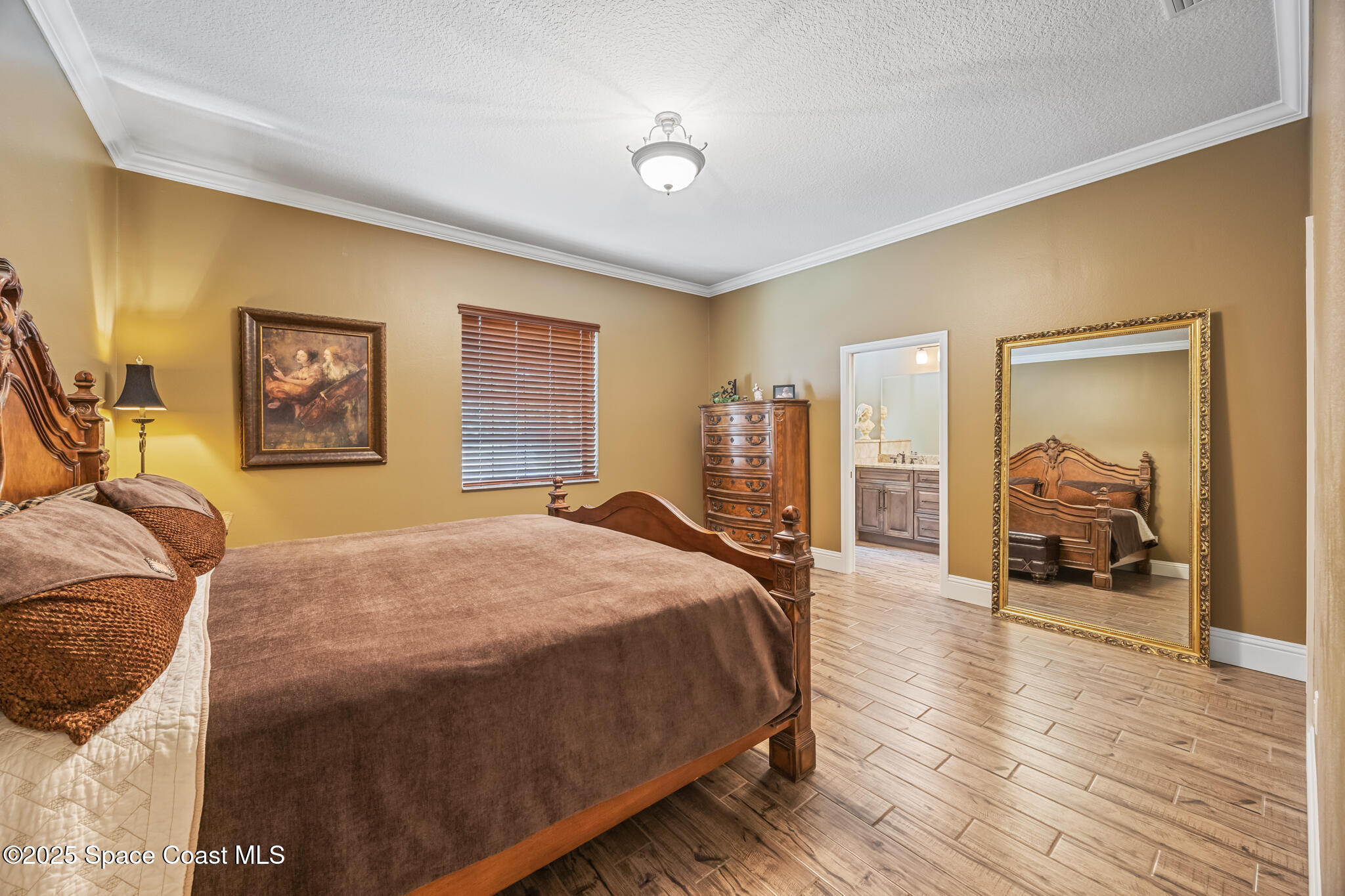 5495 Pine Street Cocoa, FL 32927 - Photo 19 of 45 a bedroom with a large bed and a chandelier