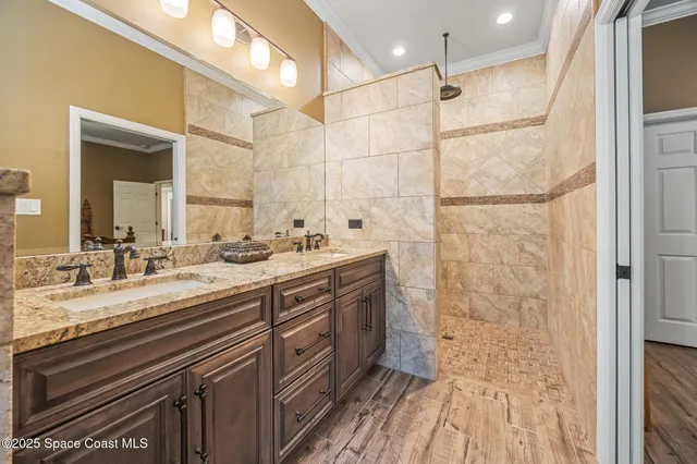 a bathroom with a double vanity sink a mirror and a shower